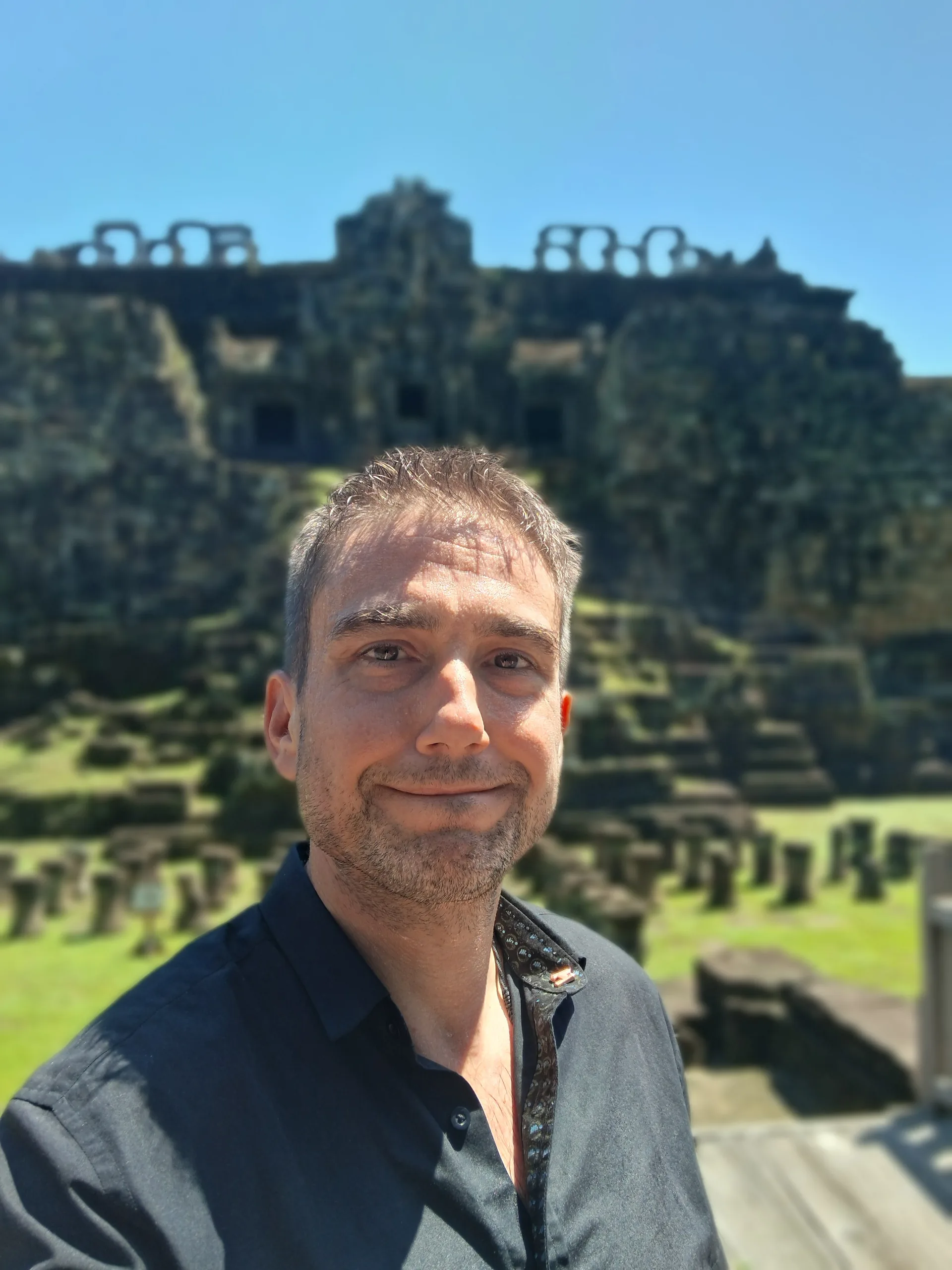 Mike Michelini with a historic temple facade near Siem Reap